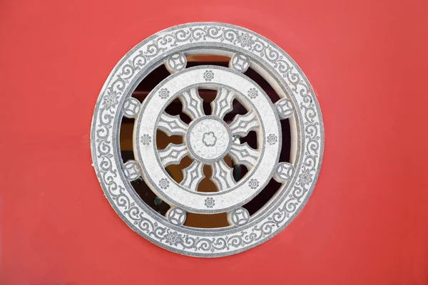 Stone rosette relief - window made of decorated stone relief, ornaments and relief on the red wall from Chinese buddhism temple, Fujian,China. — ストック写真