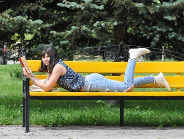 açık bir kitap tutan güzel bir kız