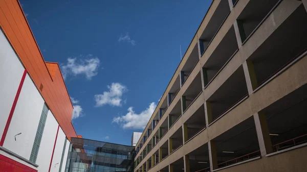 fragment of the colored facade of a parking building against the sky.