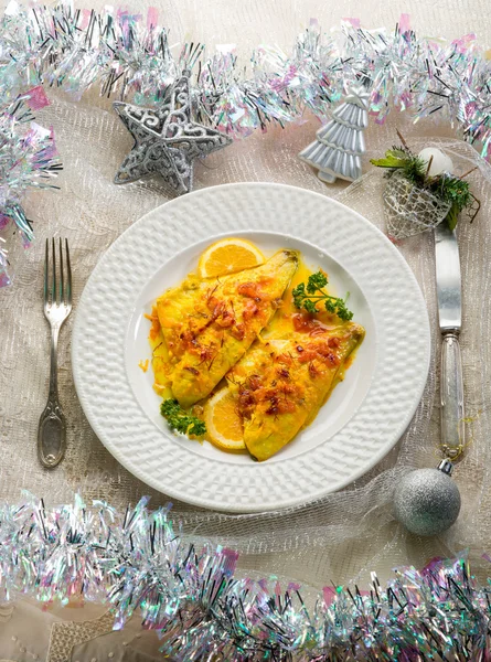 Fish fillet with saffron and orange on christmas table — Stock Photo, Image