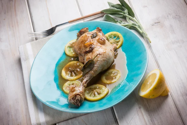 Roasted chicken leg with lemon sauce — Stock Photo, Image