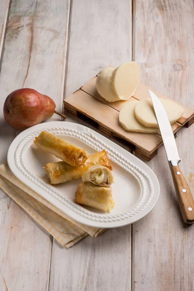 Rolled up cheese filled with pear — Stock Photo, Image