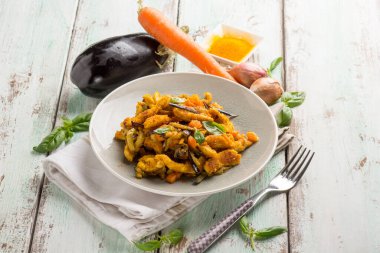 chicken stewed with eggpalnts carrots basil and turmeric spice