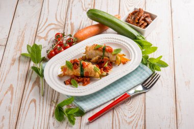 turkey rolled up with dried tomatoes zucchinis and mint leaf