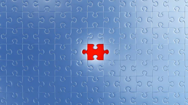 One Large Red piece of puzzle in place in the center of many other pieces — Stock Photo, Image