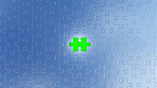 One Large Green piece of puzzle in place in the center of many other pieces — 스톡 사진