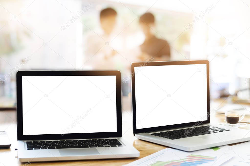 Laptops in office with business teamwork discuss