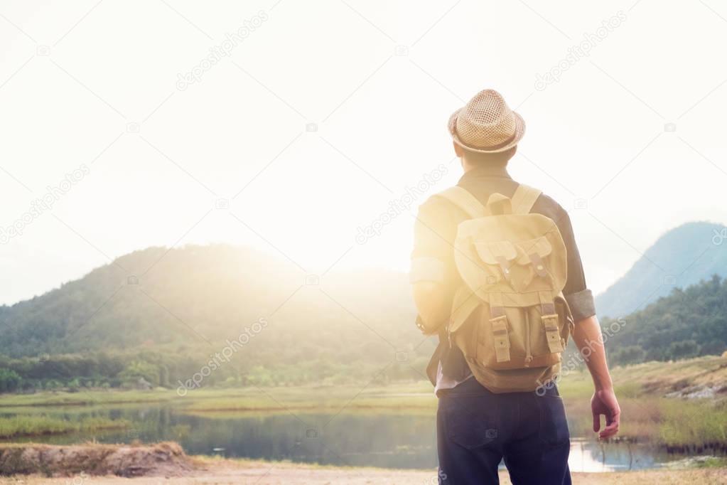 Young Man Traveler with backpack relaxing outdoor. 