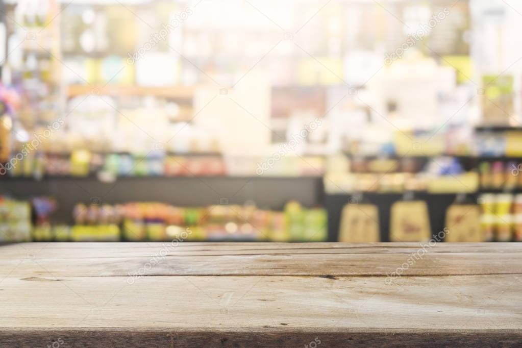 Empty wooden space platform and blurred bakery shop or coffee cafe background for product display montage.