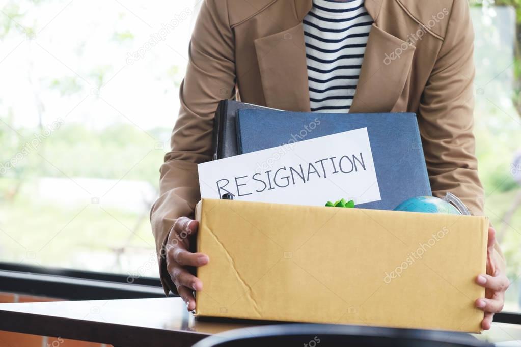 Businesswoman resignation packing up all her personal belongings