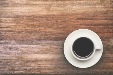 Ahşap masa arkasında kahve fincanı manzarası. 