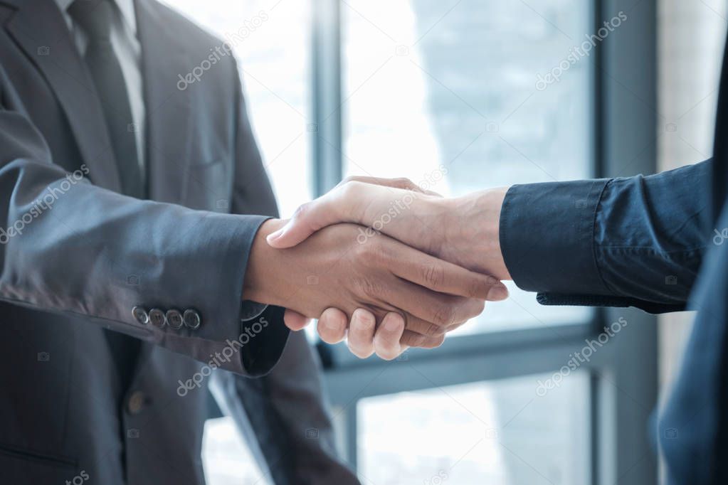 Successful businessmen handshaking after good deal