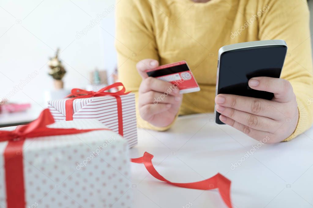 Woman holding credit card and doing shopping online. 