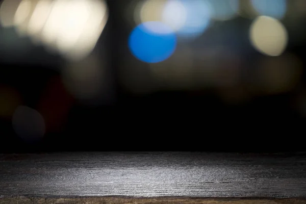 Empty wooden table platform and bokeh at night — Stock Photo, Image