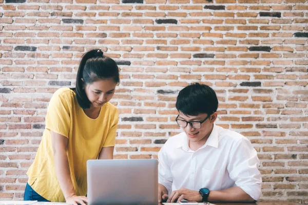 Man and woman working together.