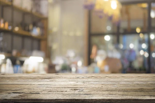 Wooden table with blur background of coffee shop — Stock Photo, Image
