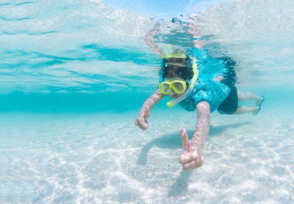 Girl in snorkeling mask dive