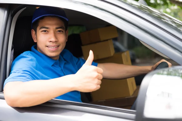 Delivery driver driving car with packages