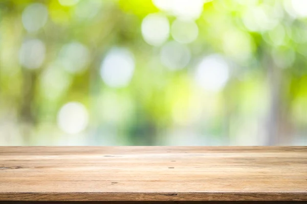 Tavolo in legno con sfondo sfocato della foresta naturale . — Foto Stock