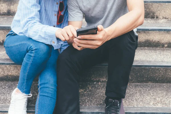 Teenage student using digital mobile phone.