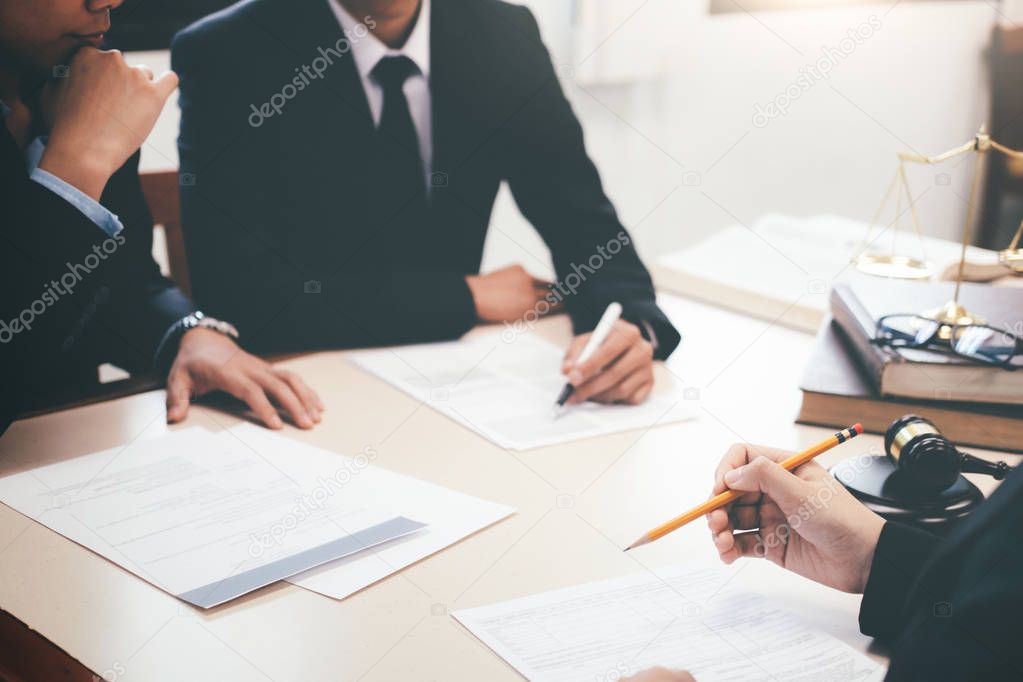 Lawyer and attorney having team meeting at law firm.