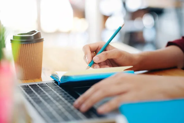 Nahaufnahme weiblicher Hände mit Stift auf Notizbuch. — Stockfoto