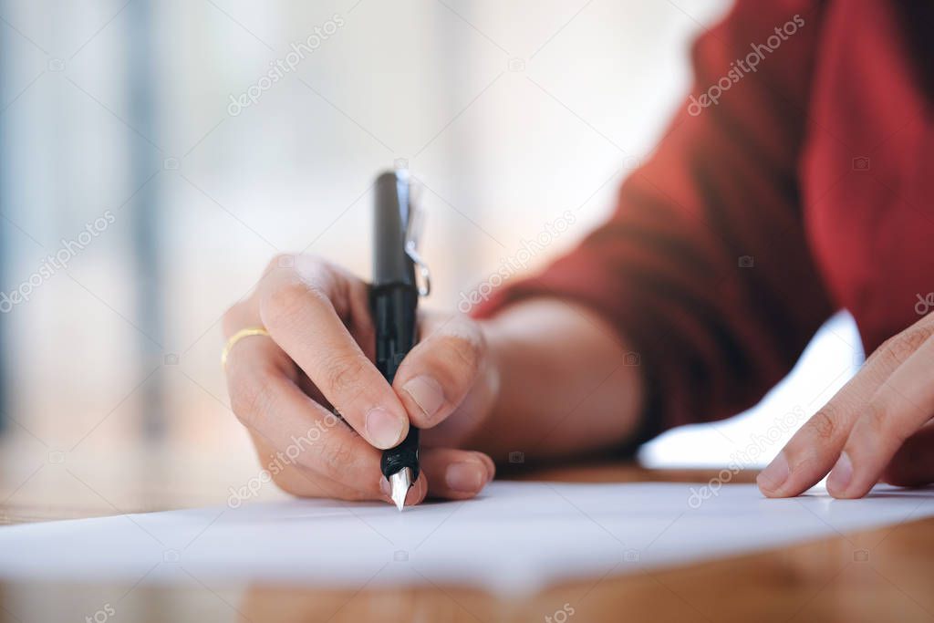 Close up businesswoman signing contract making a deal. 