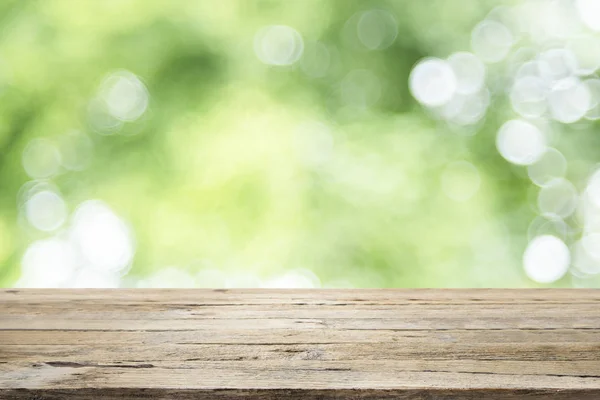 Empty table for present product with green bokeh — Stock Photo, Image