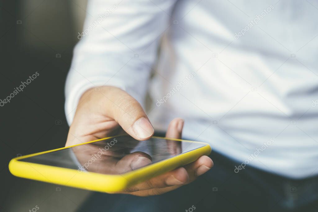 Young man using mobile phone. Using online connect technology for business, education and communication. 