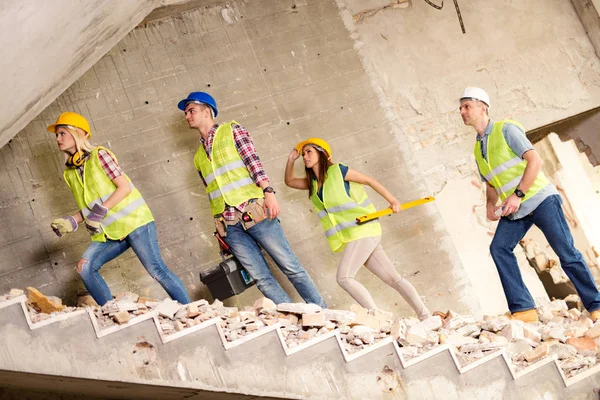 Four construction architects review plan — Stock Photo, Image