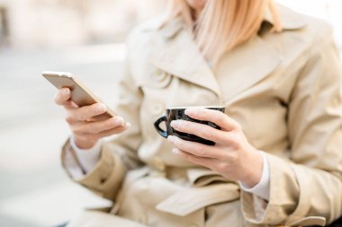 Kafede telefon kullanan kadın.