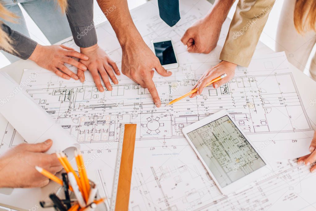 successful architect reviewing blueprints