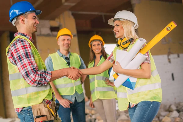 Construction architects and electrician shaking hands — Stock Photo, Image