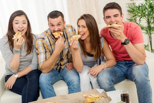 Друзья тусуются, едят пиццу Лицензионные Стоковые Изображения