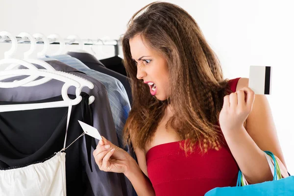 Shopper shocked by dress price tag — Stock Photo, Image