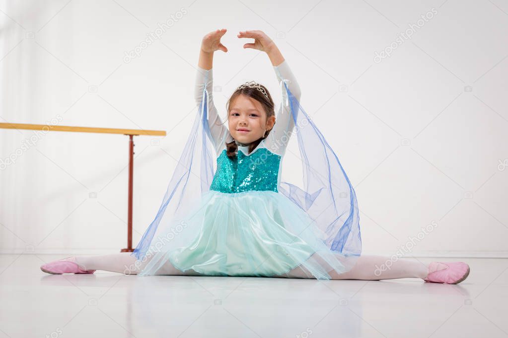 smiling little girl practicing ballet 