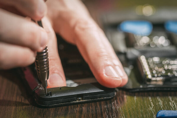 Man Repairing A Mobile phone