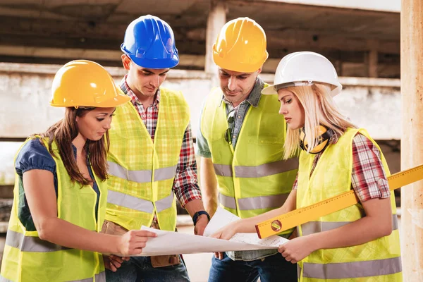 Architects looking at plan in damaged building — Stock Photo, Image