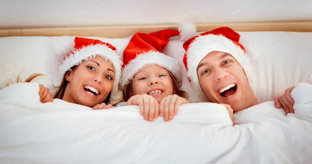 Christmas Family having fun in bed