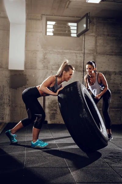 Woman flipping tire on cross fit — Stock Photo, Image