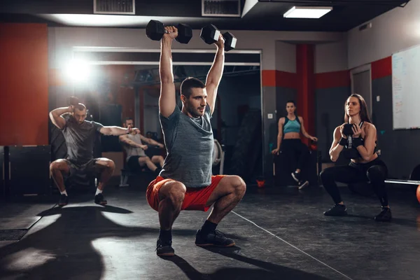 Young friends doing hard exercise — Stock Photo, Image