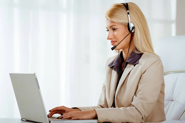 Beautiful smiling woman with a headset — Stock Photo, Image
