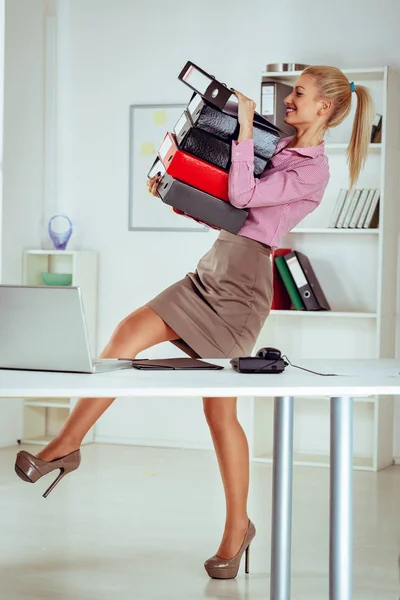 Woman with a stack of binders — Stock Photo, Image