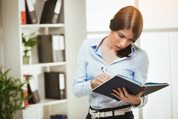 Woman standing at the office Stock Image