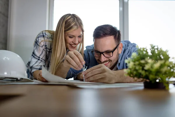 Young Successful Architect Colleagues Analyzing Blueprints Drawing Divider While Working — Stock Photo, Image