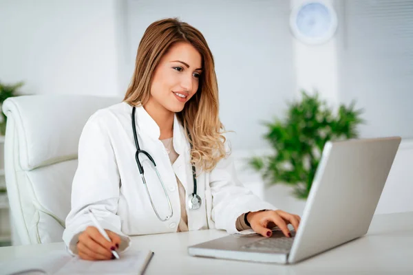 Young Female Doctor Writing Laptop Checking Medical Records Consulting Room — Stock Photo, Image