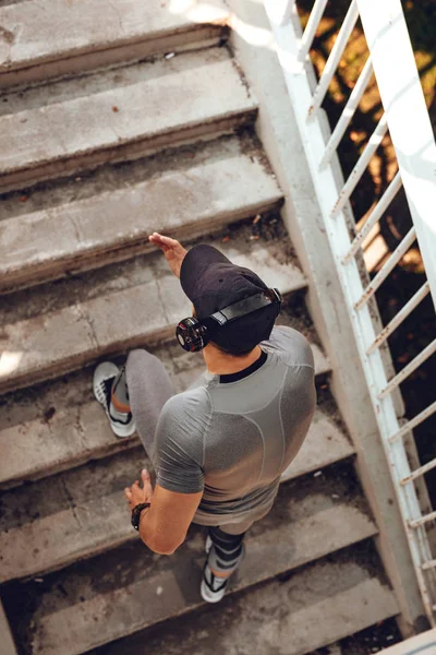 Молодой Мускулистый Спортсмен Наушниках Бегает Лестнице Мосту — стоковое фото