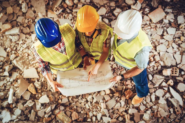 Three Construction Architects Review Plan Building Damaged Disaster — Stock Photo, Image