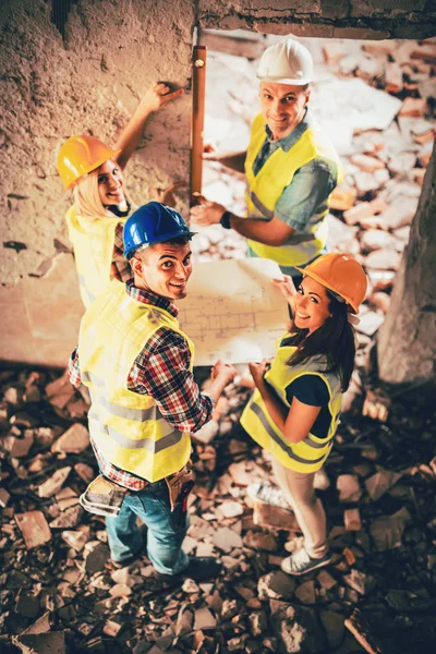 Four Construction Architects Review Building Plan Reconstruction Damaged Disaster — Stock Photo, Image