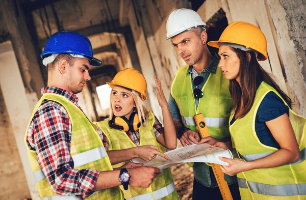 Four Construction Architects Review Building Plan Reconstruction Damaged Disaster — Stock Photo, Image